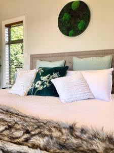 a bedroom with a large bed with pillows at Wairimu View Lodge in Waipu