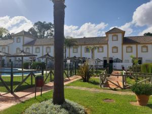 a resort with a palm tree in the foreground at Playa Golf IV in Islantilla