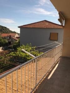a balcony of a house with a fence at Apartmani Stupin Čeline in Podglavica