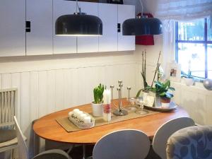 a table in a kitchen with a dining room at Holiday home SÄRNA in Särna