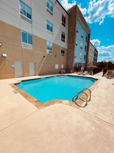 a swimming pool in front of a building at Holiday Inn Express - Macon North, an IHG Hotel in Macon