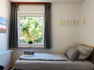 a bed in a room with a window at urbanAPARTMENT No.2 Memmingen in Memmingen