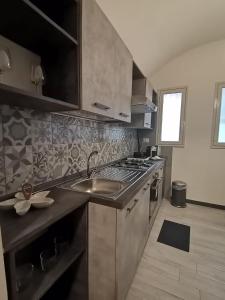 a kitchen with a sink and a stove at Agata dreams apartment in Catania