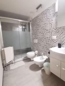 a bathroom with a toilet and a sink and a shower at Agata dreams apartment in Catania +18 photos