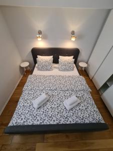 a bed in a room with two pillows on it at Arsenal Apartments in Zadar