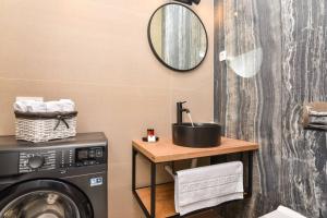 a bathroom with a sink and a washing machine at New & Luxury 5* with Breathtaking View- Kiki Lu Apartment in Dubrovnik +43 photos