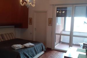 a bedroom with a bed and a large window at Dalla Bosh 2 in Parma +2 photos