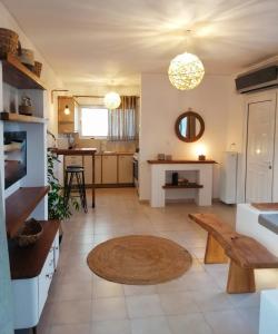 a living room with a bench and a kitchen at Elia Luxury Apartment in Eretria