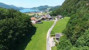 ariaal uitzicht op een huis op een heuvel met een weg bij Haus Berger in Fuschl am See