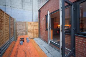 um quarto com um banco de madeira num edifício em higgihaus #3a & 3b 8 Bed Sleeps up to 22 Big Groups Hip Location em Bristol