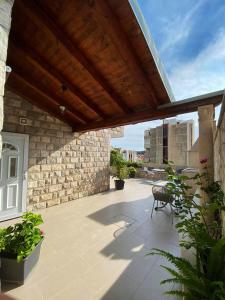 an outdoor patio with a wooden pergola at Apartments Adaleta in Dubrovnik