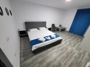 a bedroom with a bed and a table and a chair at Vila Paradis Costinesti in Schitul +28 photos