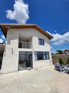 a house with a large driveway in front of it at Vila Paradis Costinesti in Schitul