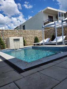 a swimming pool in front of a house at Vila Paradis Costinesti in Schitul