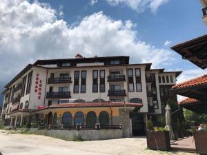 a large white building with a yellow trim at GONDOLAs LODGE in Bansko