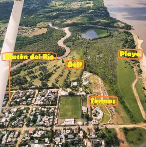 an aerial view of an island with houses andyards at Cabañas Rincón del Río in Colón