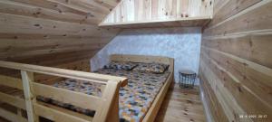 a bedroom with two bunk beds in a log cabin at Apartmani Vuk in Kolašin