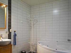 a bathroom with a shower and a tub and a sink at Holiday home Bovallstrand V in Bovallstrand