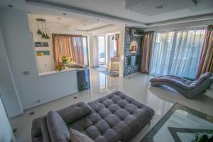 a living room with a couch and a chair at Golden Apartments in Ulcinj +102 photos