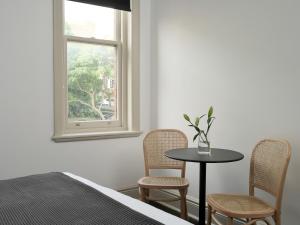 a bedroom with a table and two chairs and a window at Dunkirk Hotel Pyrmont in Sydney +17 photos