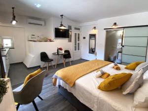 a bedroom with a large bed and a kitchen at Waterfront Apartment PROSPER - Hvar in Hvar
