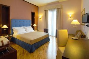 Postel nebo postele na pokoji v ubytování Hotel Messenion