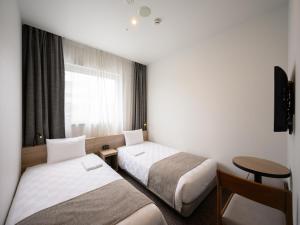 Postel nebo postele na pokoji v ubytování Nagano Tokyu REI Hotel