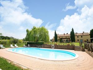 a swimming pool in a yard with a house in the background at Apartment in Collesalvetti near Pisa in Guasticce +32 photos