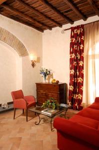 a living room with a red couch and a table at Residenza San Calisto in Rome