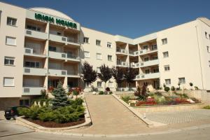 a large apartment building with a parking lot at Irish House Međugorje in Međugorje