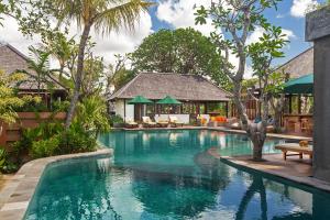 a swimming pool in front of a villa at Alam Wayang Ubud - CHSE Certified in Ubud