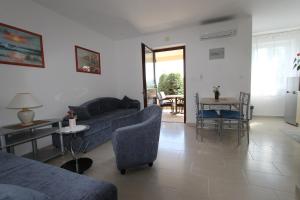 a living room with a couch and a table at Apartments Mareblu in Rabac