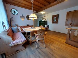 a living room with a couch and a table at Appartements Zauchenseeblick Thunhart in Altenmarkt im Pongau