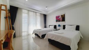 a hotel room with two beds and a window at City Plaza Nana Hotel in Bangkok +149 photos