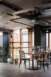a group of tables and chairs in a room at Alex Hotel in Perth