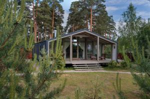 a small cabin in the woods with trees at Talitsy Lodge in Talitsa