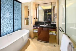 a bathroom with a tub and a sink at Crowne Plaza Chengdu Panda Garden, an IHG Hotel in Chengdu