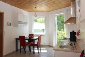 a kitchen with a table and chairs and a window at Ferienwohnung Im Tal Olsberg in Olsberg
