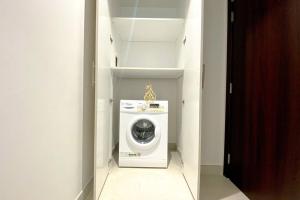 a laundry room with a washing machine in a closet at Dania 3 Midtown - AL Maraseem in Dubai