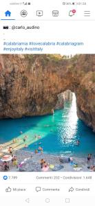 a photo of a beach with people swimming in the water at Quiero Más B&B in San Nicola Arcella