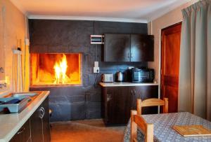- une cuisine avec une cheminée dans l'établissement Baviaanskloof Guest Cottages, à Studtis 16 autres photos