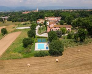 an aerial view of a house with a swimming pool in a field at Corte Tommasi Residence in Orentano