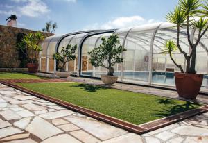 a greenhouse with trees and plants in it at Dii Beach House - Casa de Férias com piscina interior aquecida in Torres Vedras