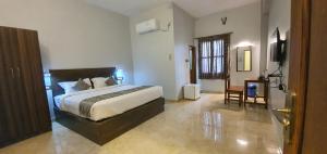 a bedroom with a large bed in a room at Le Supreme Inn (the lap of luxury) in Puducherry