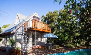 a house with a deck next to a swimming pool at Squirrel's End in Cape Town