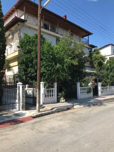 a building on a street with a white fence at Cosy studio 35m2 in Síndos