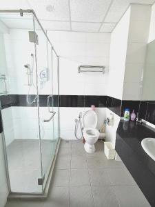 a bathroom with a shower and a toilet and a sink at Mansion One, Private Room in George Town