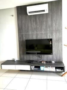 a entertainment center with a tv on a wall at Mansion One, Private Room in George Town +9 photos