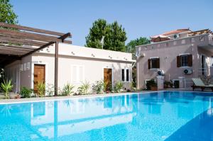 a swimming pool in front of a house at Sea and Creek in Katelios