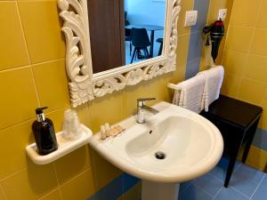 a bathroom with a sink and a mirror at B&B Blessed apartment in Perugia